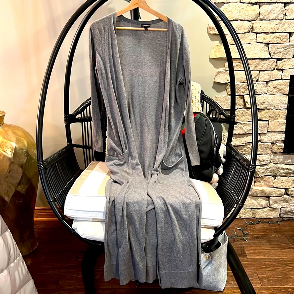 Long sweater with pockets on each side and slits.